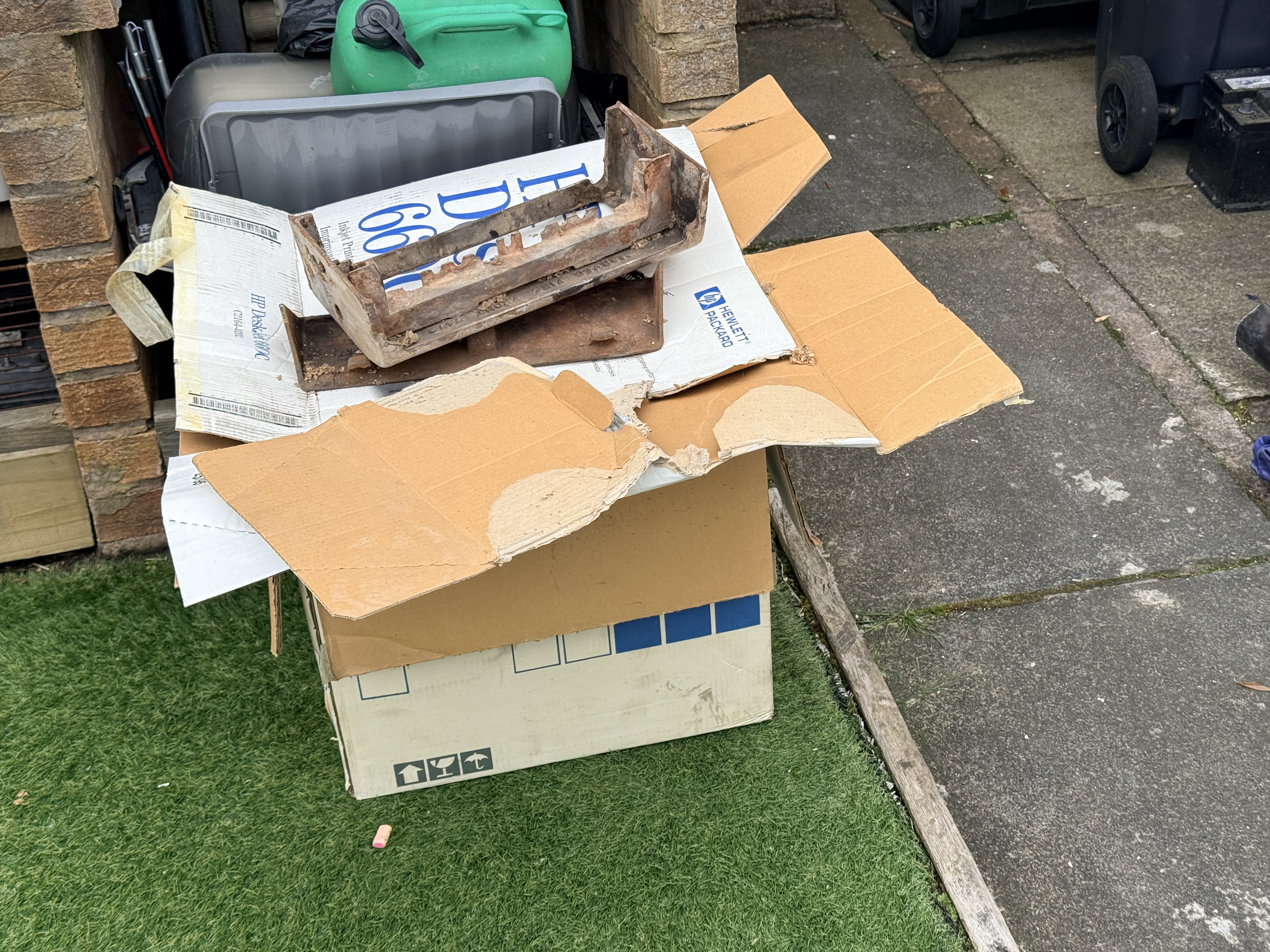 Old cast components sitting on cardboard