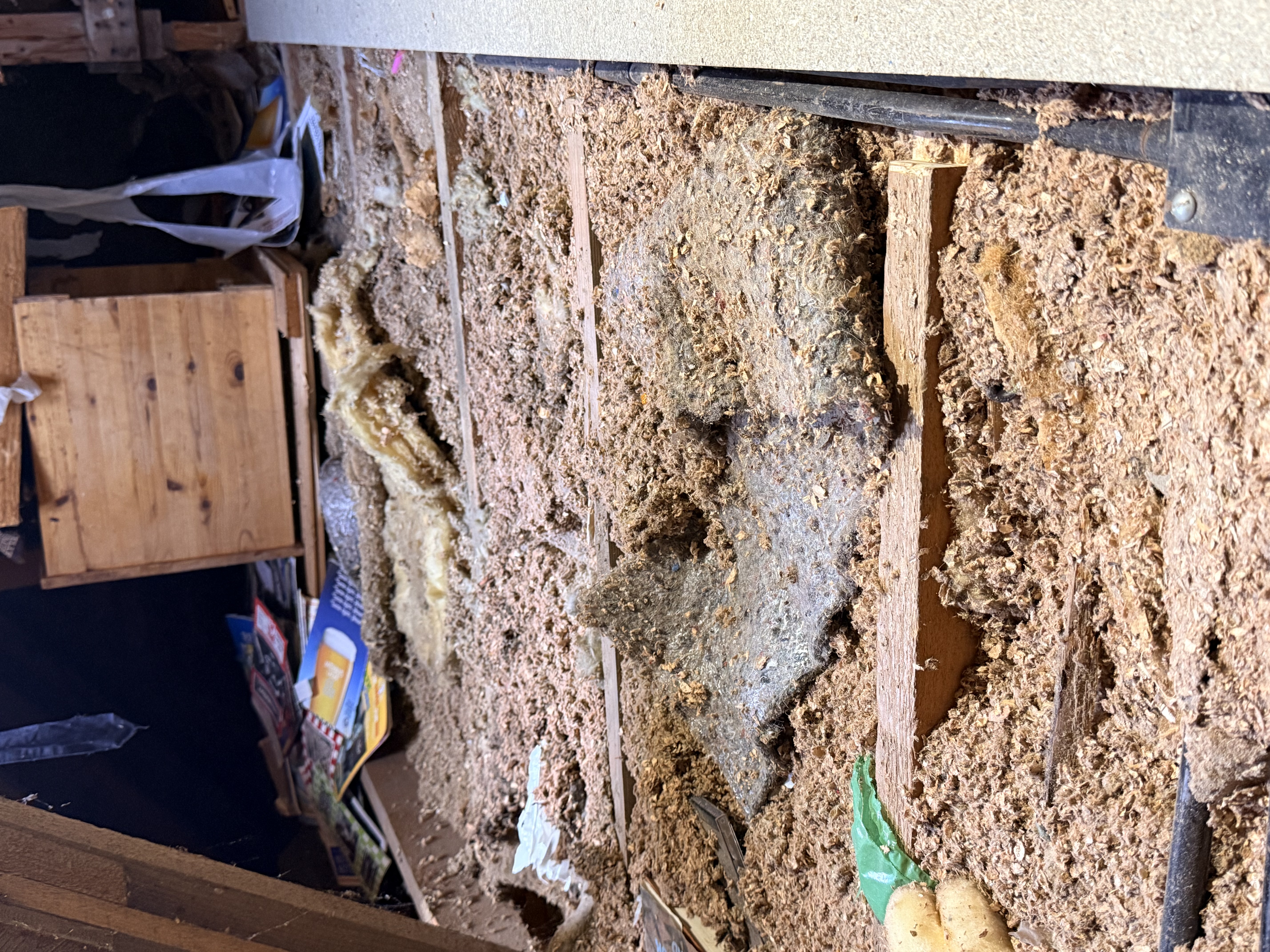 Sorting through old wood pieces and materials along the roof line